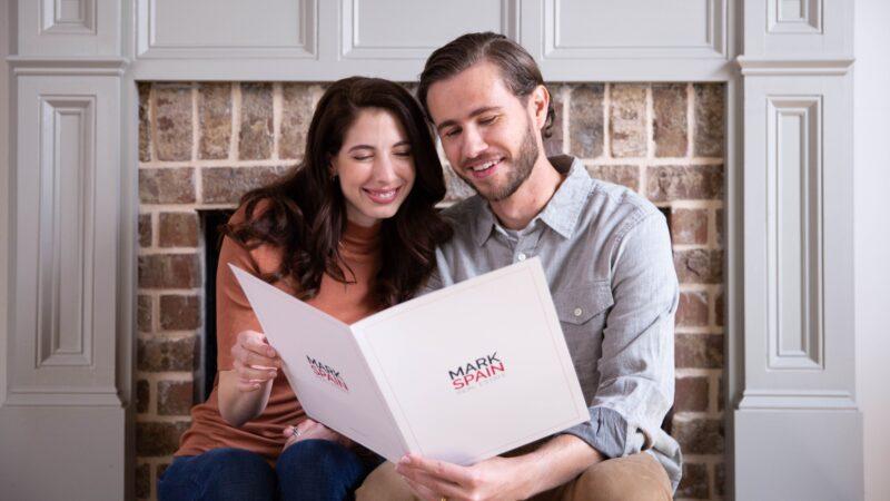 couple reading mark spain real etstae booklet - Ranjana’s Buying Experience