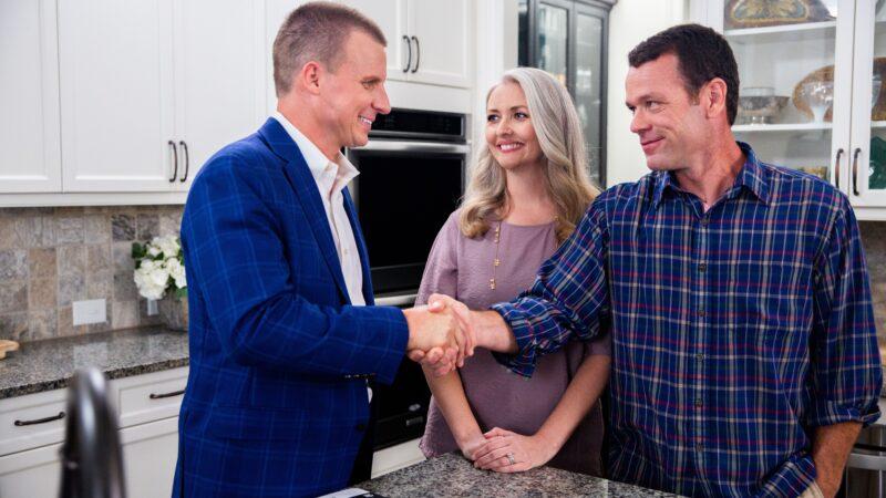 mark shaking hands woth a client in the kitchen at the counter - sarah's seamless sale