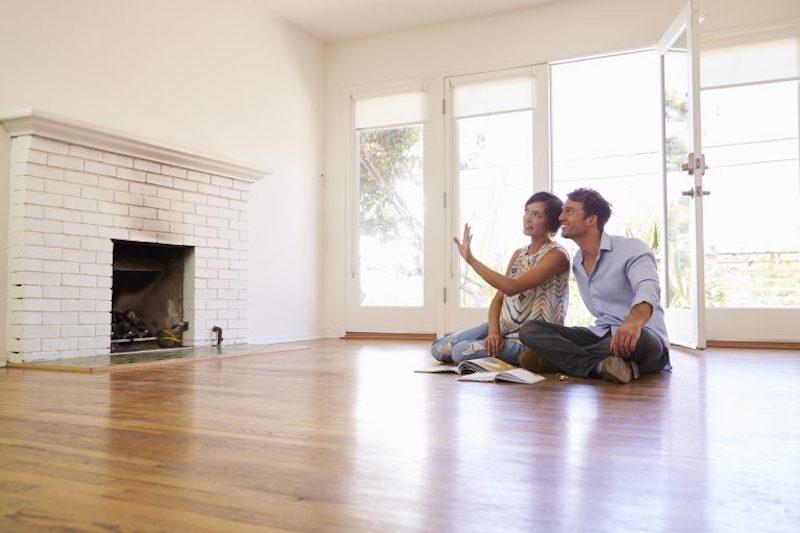 Excited Couple Planning Decoration Of New Home