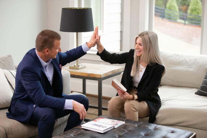 Mark Spain and an Agent at a showing celebrating a win