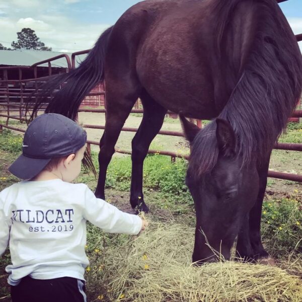 Ryan Byerly making a difference in Raleigh with his son feeding a horse