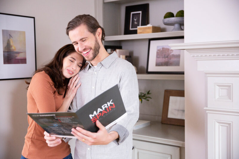 A happy couple viewing their selling options MSRE offers to Selling your home