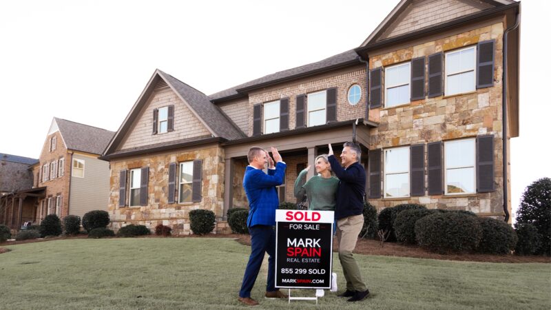 Mark Spain cheering on Fort Worth real estate clients after the sale of their home