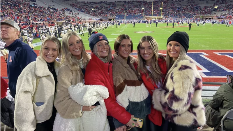Shea Seibert, Marketing Specialist at Mark Spain Real Estate enjoys a football game with her friends at Ole Miss.