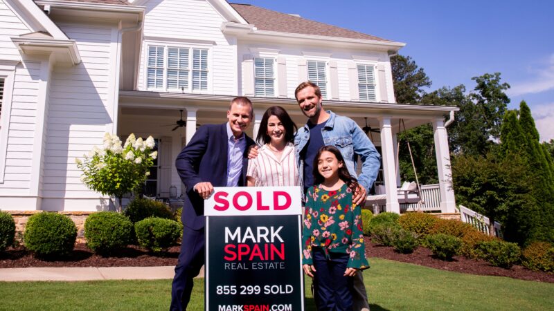 Mark and his clients after experiencing a successful sale of their home